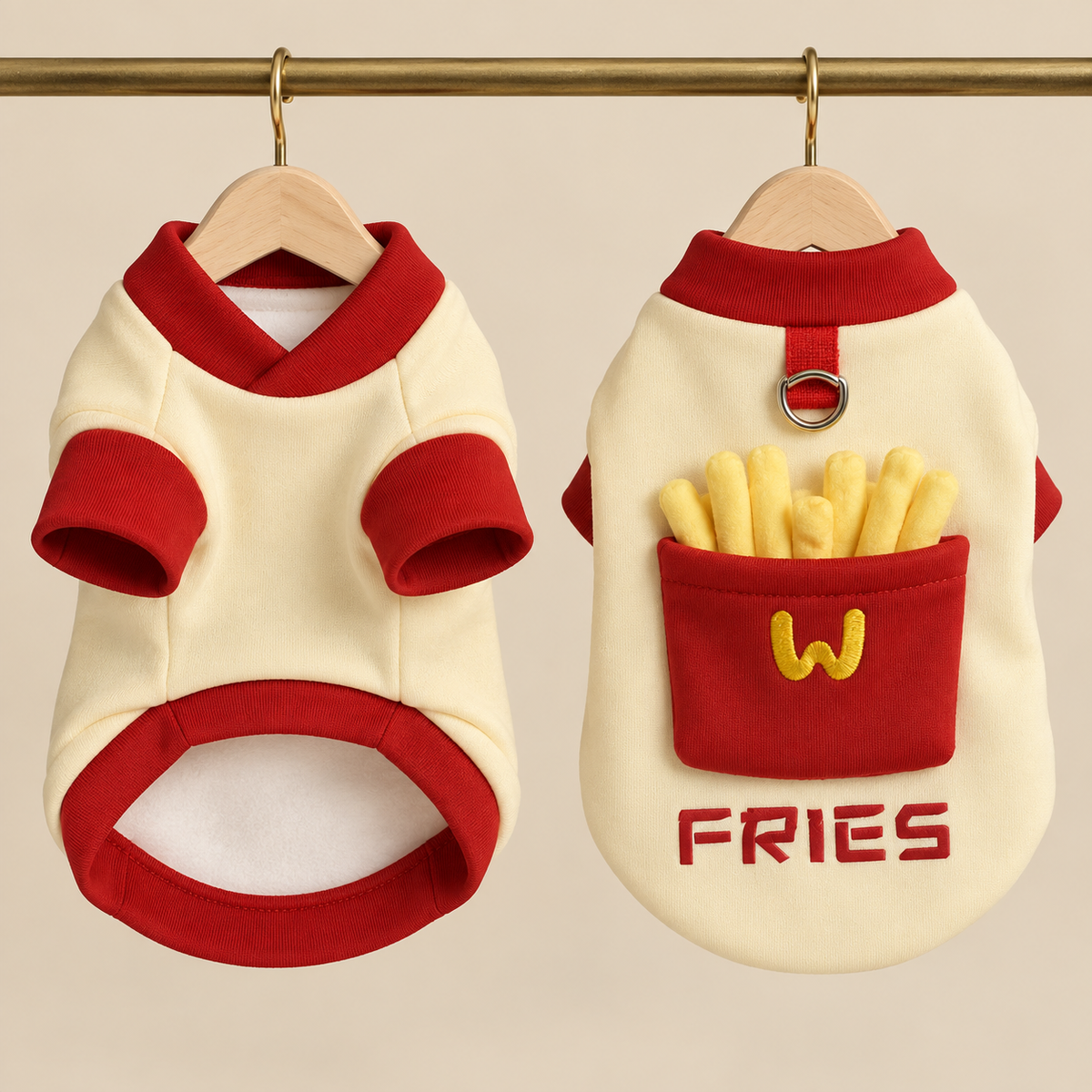 Cream fleece dog sweatshirt with red ribbed collar and cuffs and a red fries carton pocket holding plush fries, shown front and back on hangers