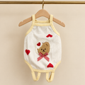 Ivory ribbed cotton pet bodysuit with butter yellow binding, a bear patch with red gingham bow and red heart appliques