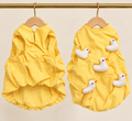 Butter yellow cotton pet smock with a gathered hem and five white plush duckling appliques