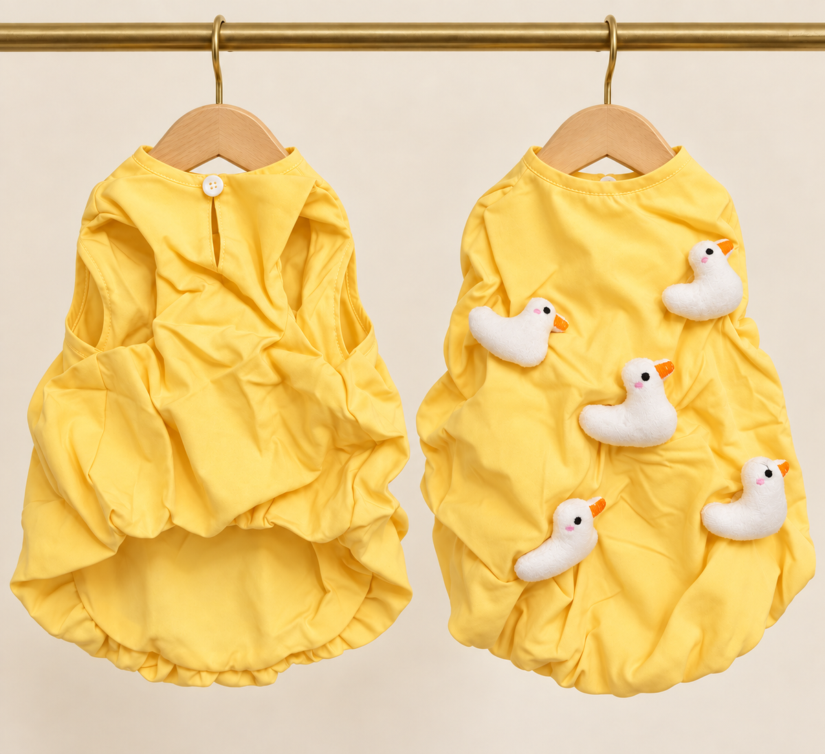 Butter yellow cotton pet smock with a gathered hem and five white plush duckling appliques