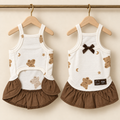 Ivory pointelle pet dress printed with brown teddies and stars, with a gathered brown skirt and brown satin bow