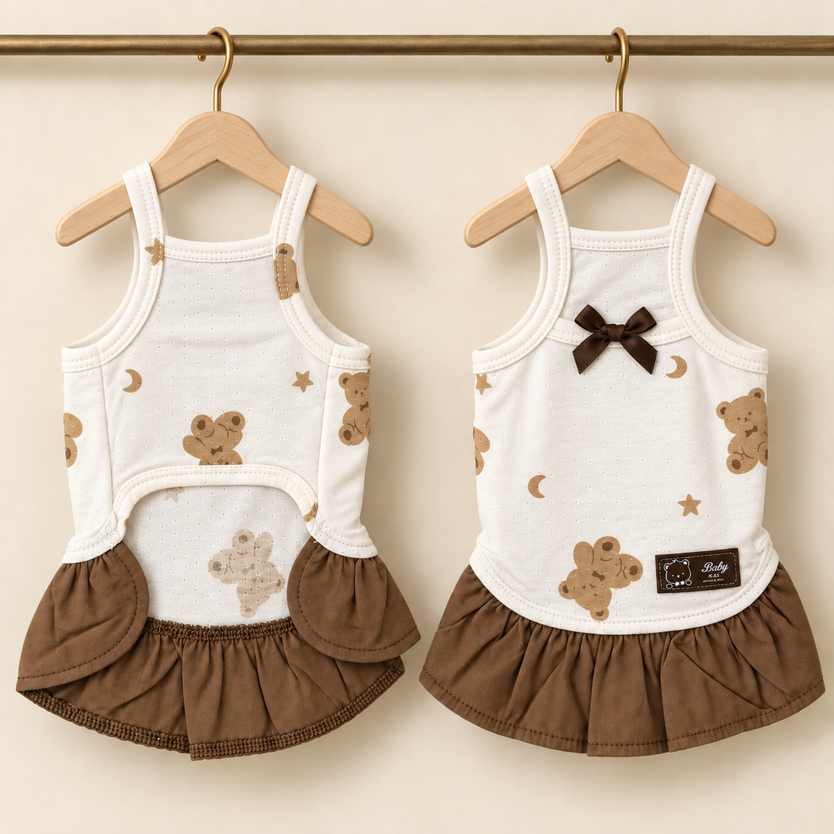 Ivory pointelle pet dress printed with brown teddies and stars, with a gathered brown skirt and brown satin bow