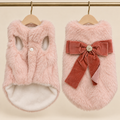 Blush faux fur pet vest lined in cream fleece with a pearl button and a rust velvet bow centred on an enamel camellia