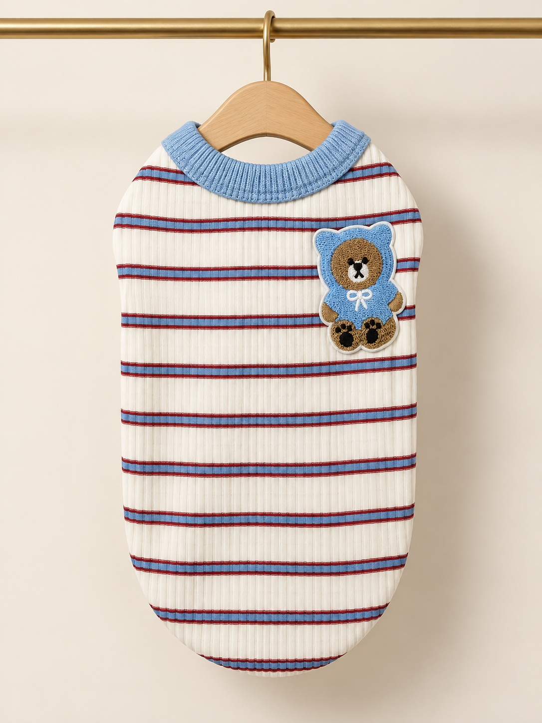 Cream ribbed pet tank with blue and red stripes, blue ribbed collar and a bear-in-a-hoodie patch